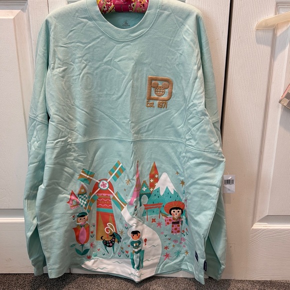 SPIRIT JERSEY Tops - NWT It’s a Small World Spirit Jersey L